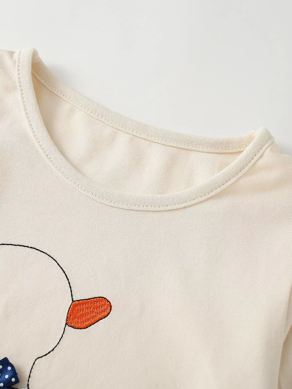 Cream round neckline and duck motif