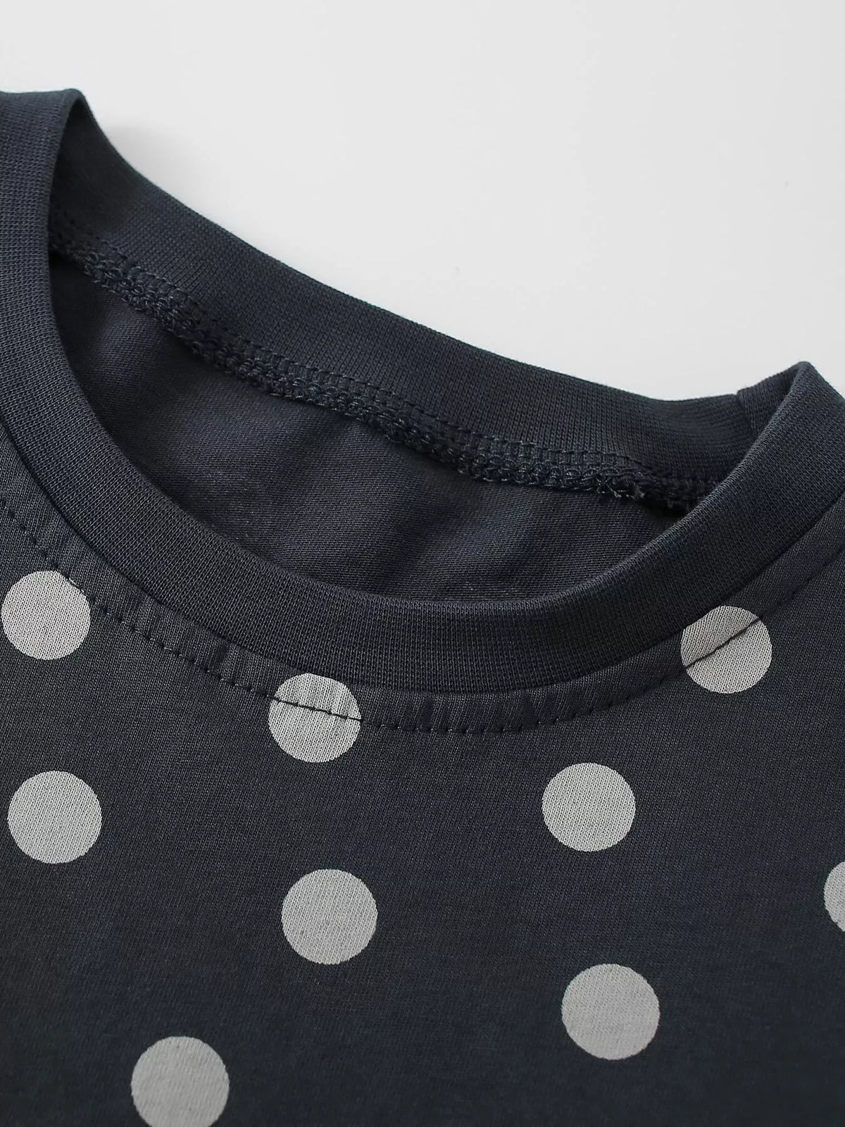 Black round neckline and pale dots