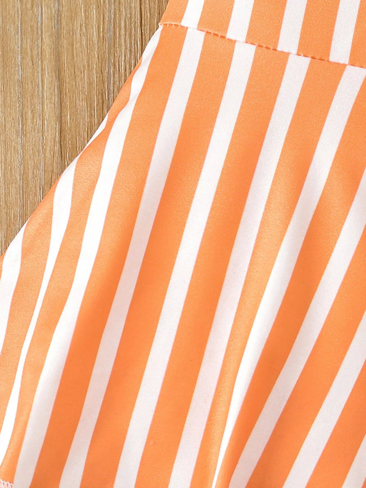 Orange striped fabric at the flared leg seam
