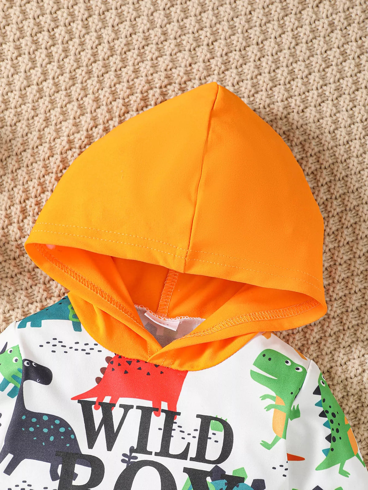 Dinosaur Wild Boy hooded bodysuit and orange pants — orange hood and wild boy lettering