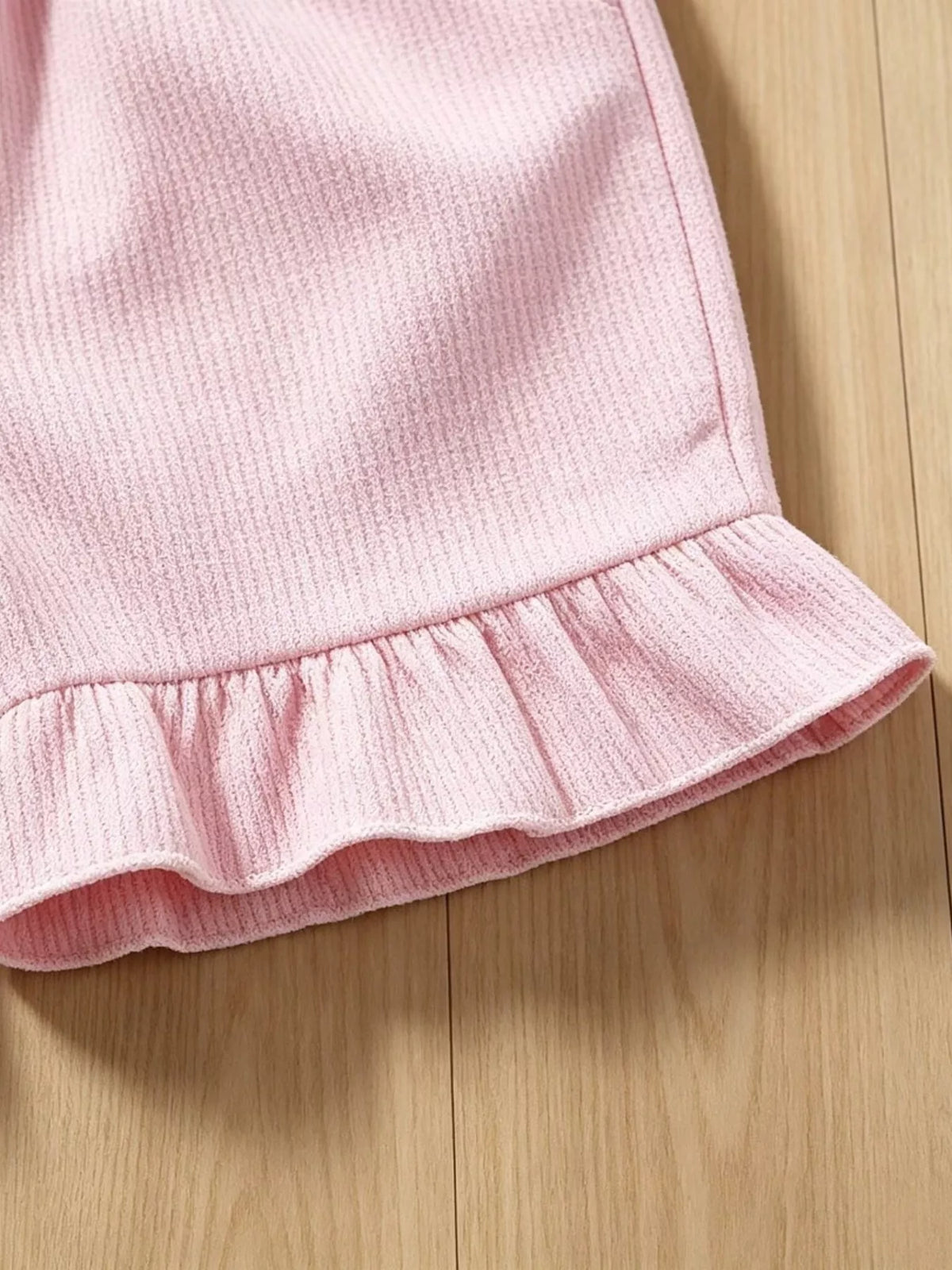 Ruffled hem on pink shorts