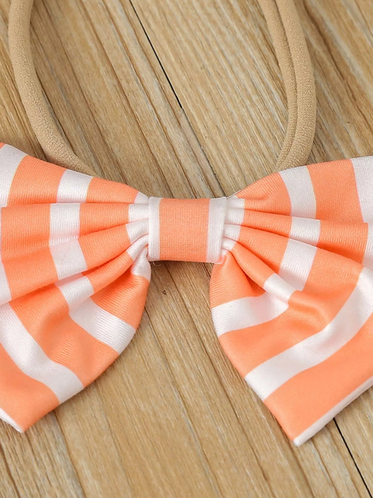 Orange-and-white striped bow headband