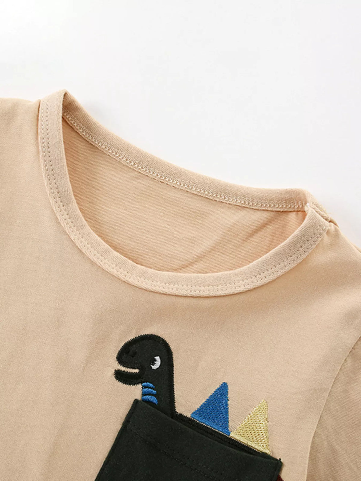 Beige dinosaur pocket shirt — round neckline