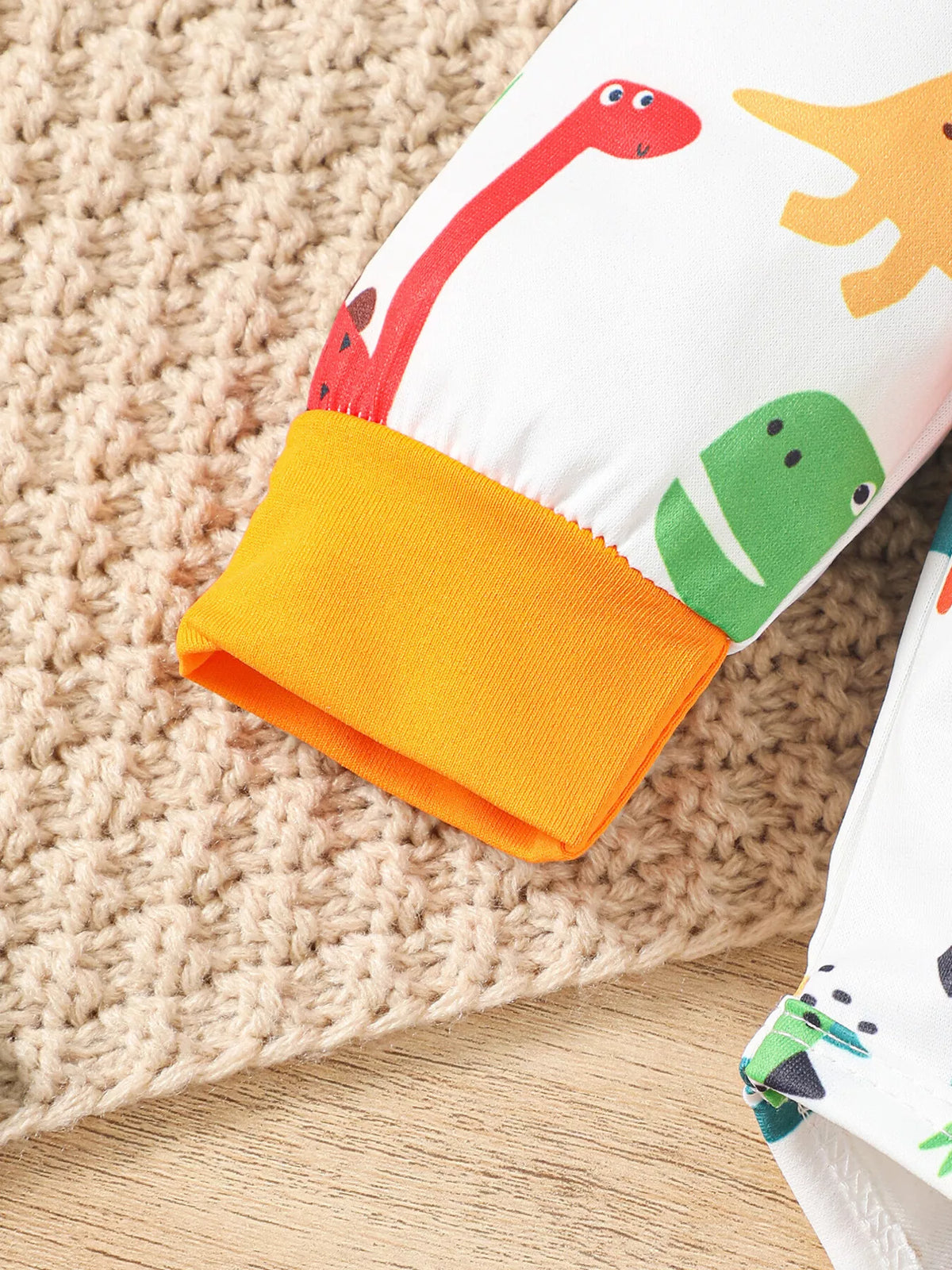 Dinosaur Wild Boy hooded bodysuit and orange pants — orange sleeve cuff