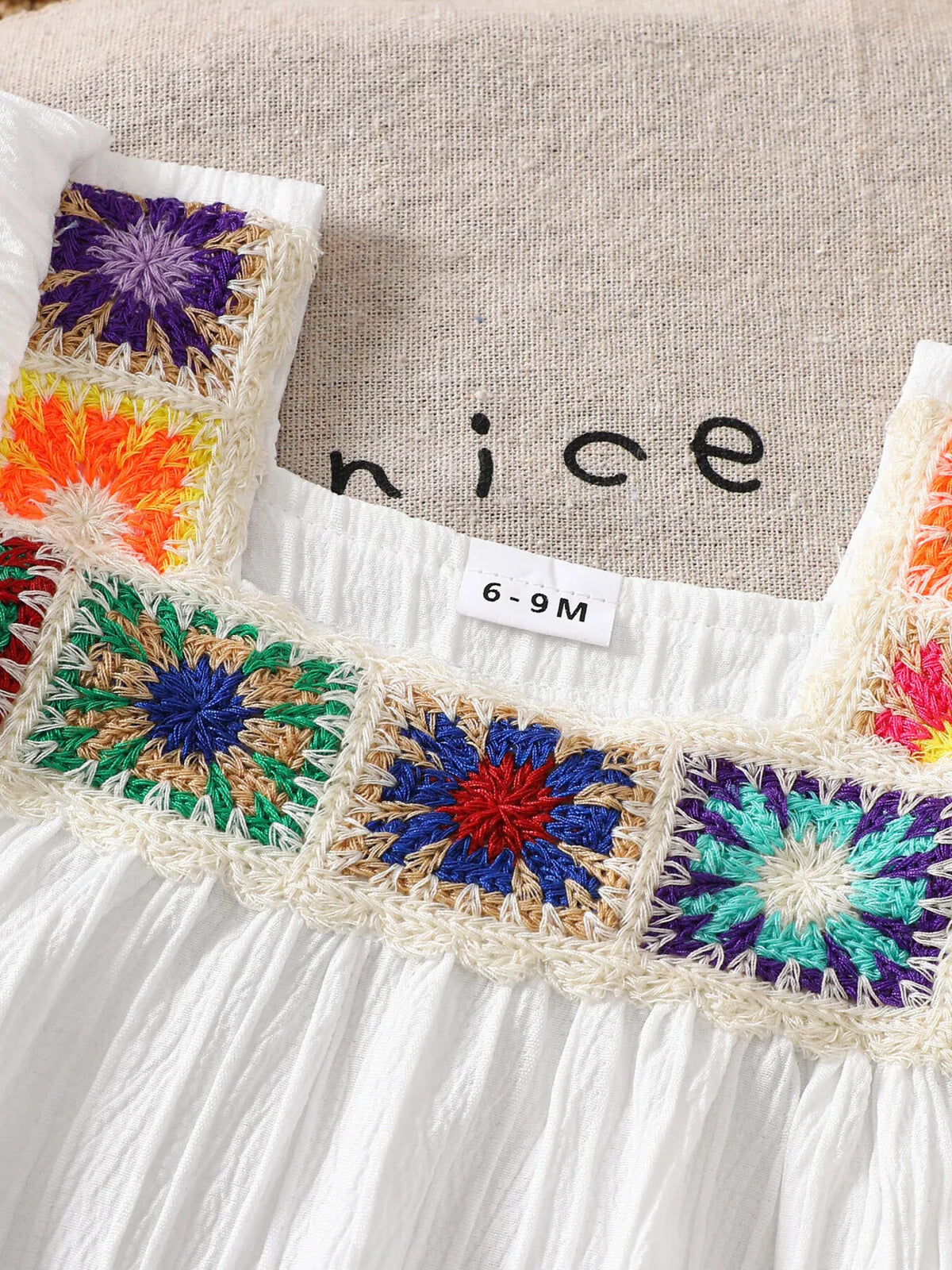 Multicolored crochet squares around the square neckline