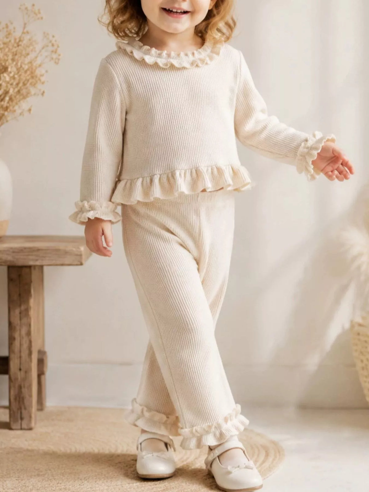 Cream ruffle-trimmed outfit on a child