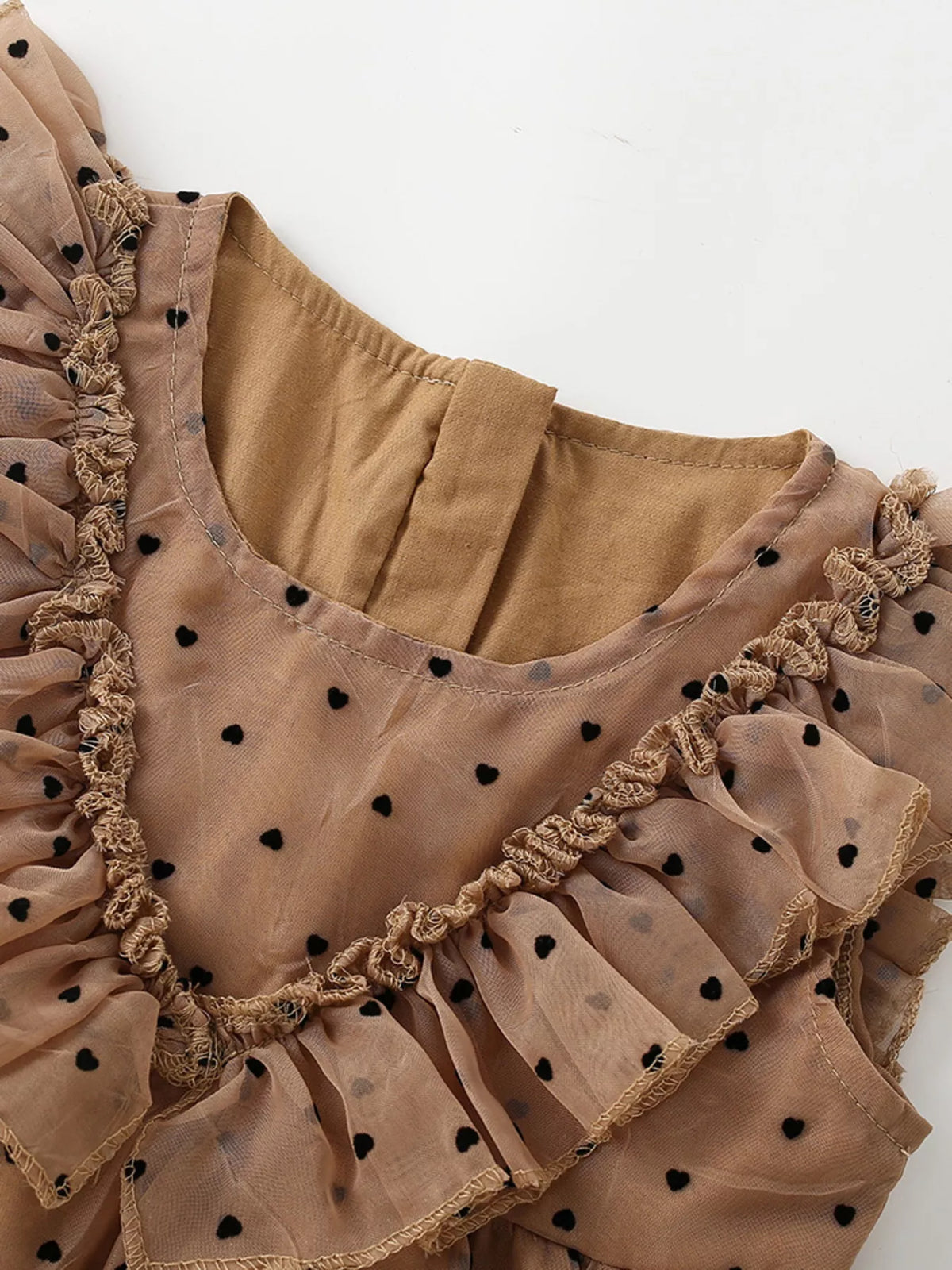 Round neckline and V-shaped ruffle trim