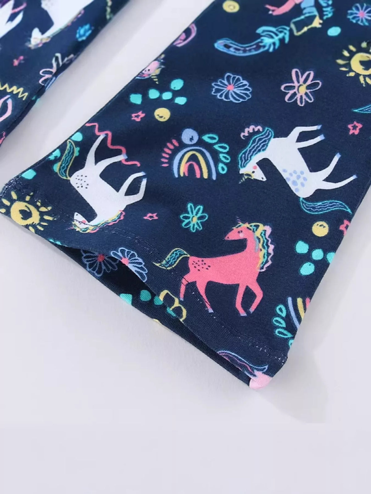 Unicorns and rainbows on the flared leg hem