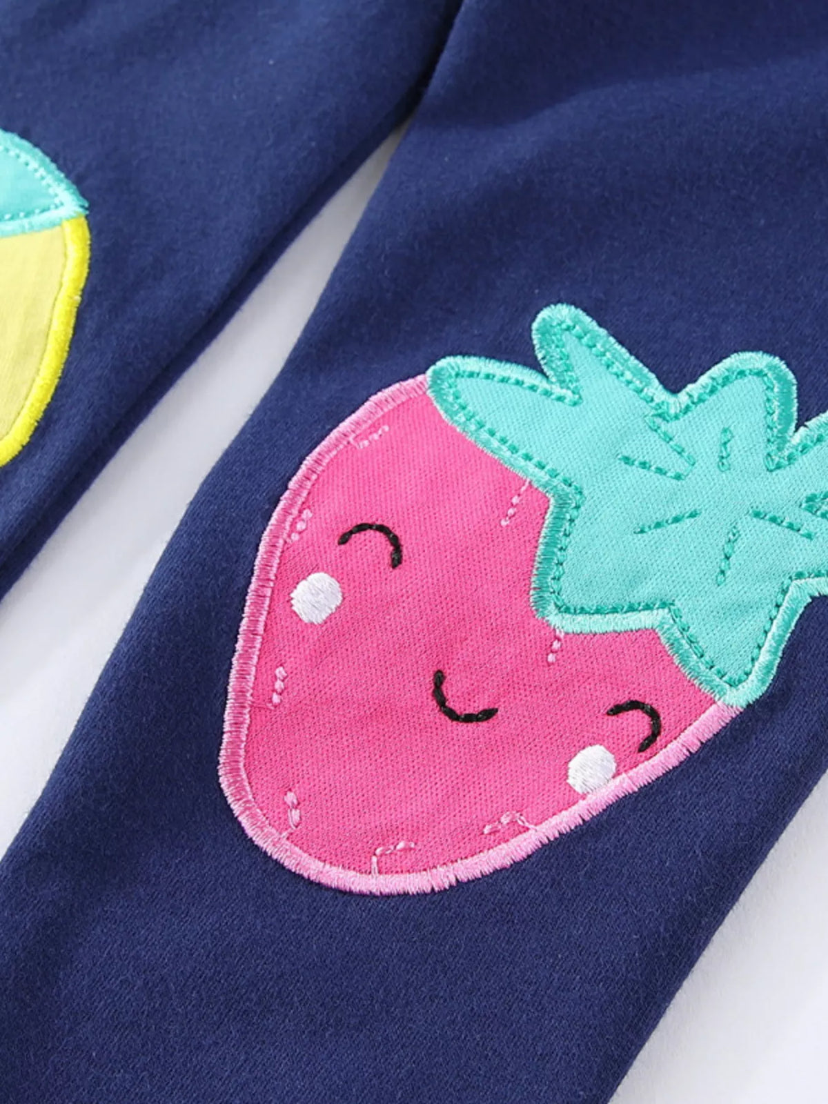 Smiling pink strawberry applique with green leaves