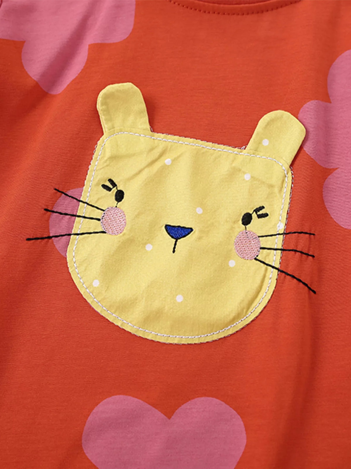Yellow cat-face applique with stitched whiskers