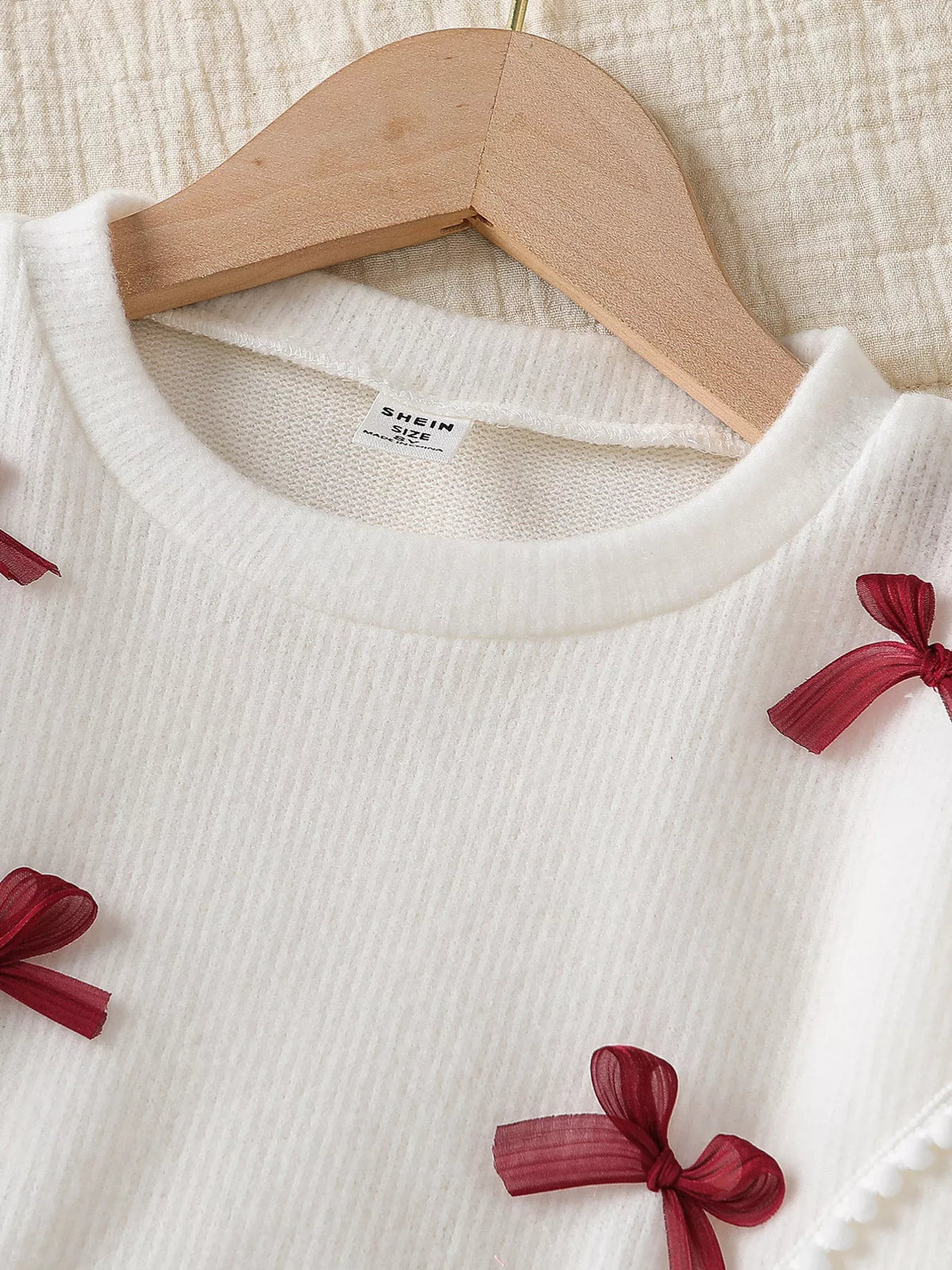 Cream round neckline and small burgundy bows