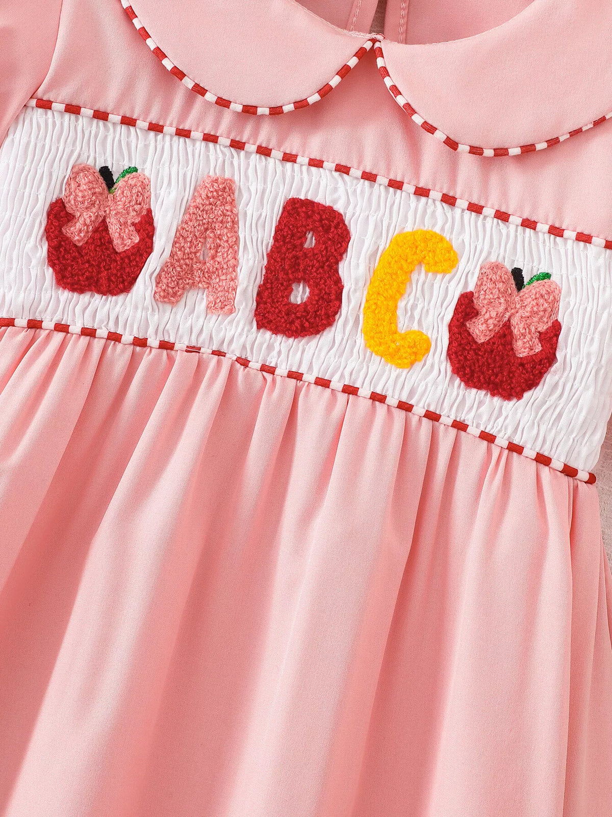 ABC lettering and apple embroidery on the smocked band