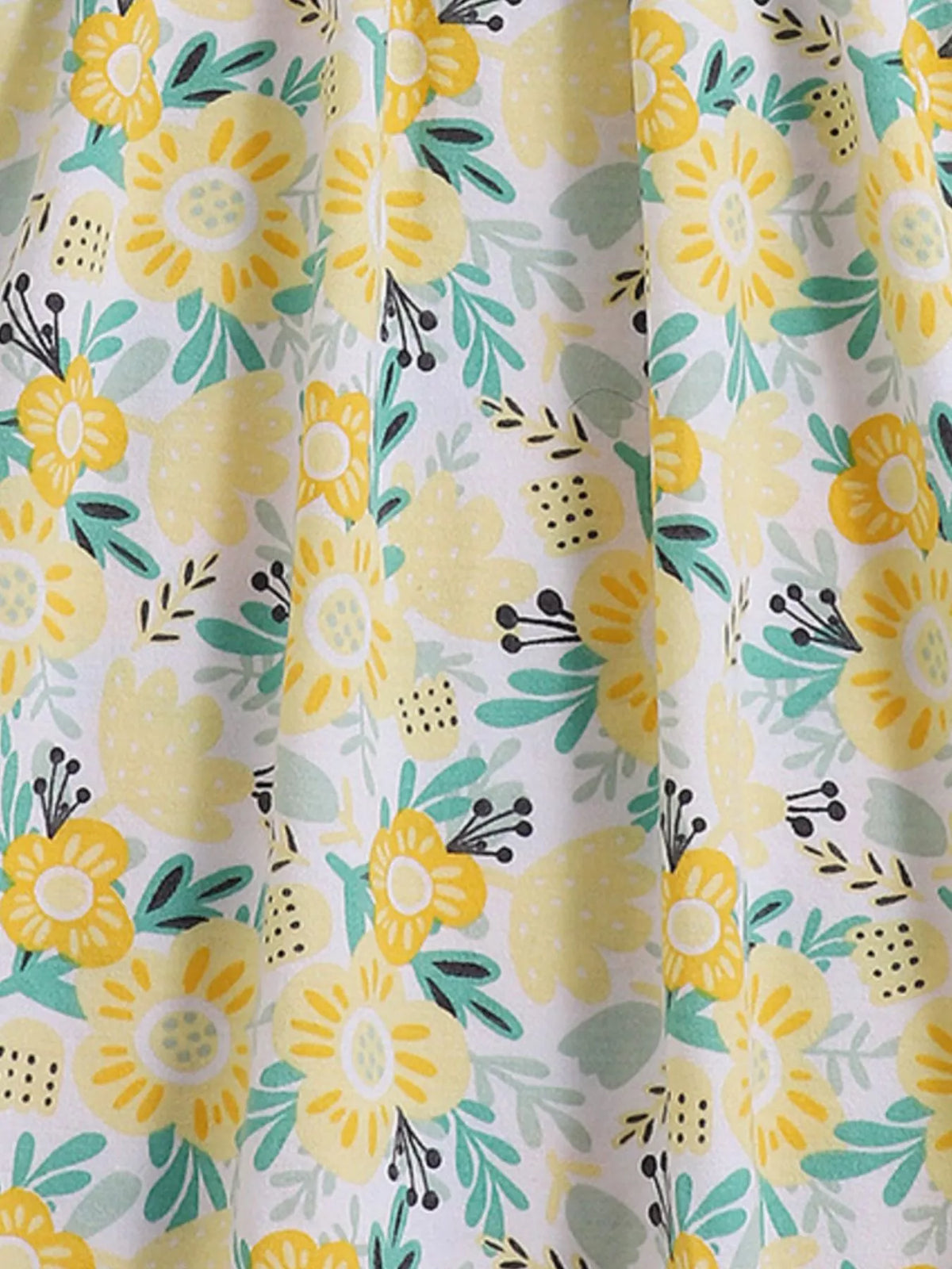 Yellow flowers and green leaves on pale fabric