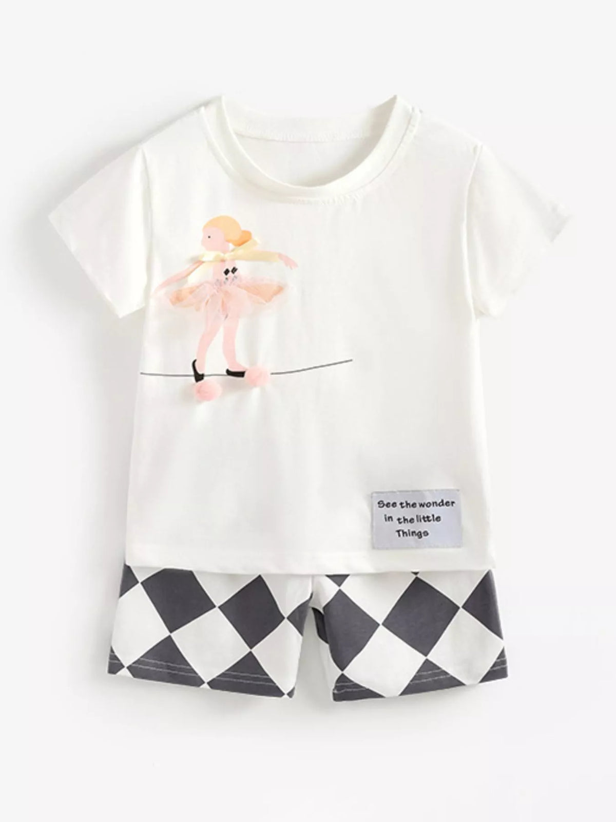 White ballet-dancer tee with black-and-white diamond shorts laid flat