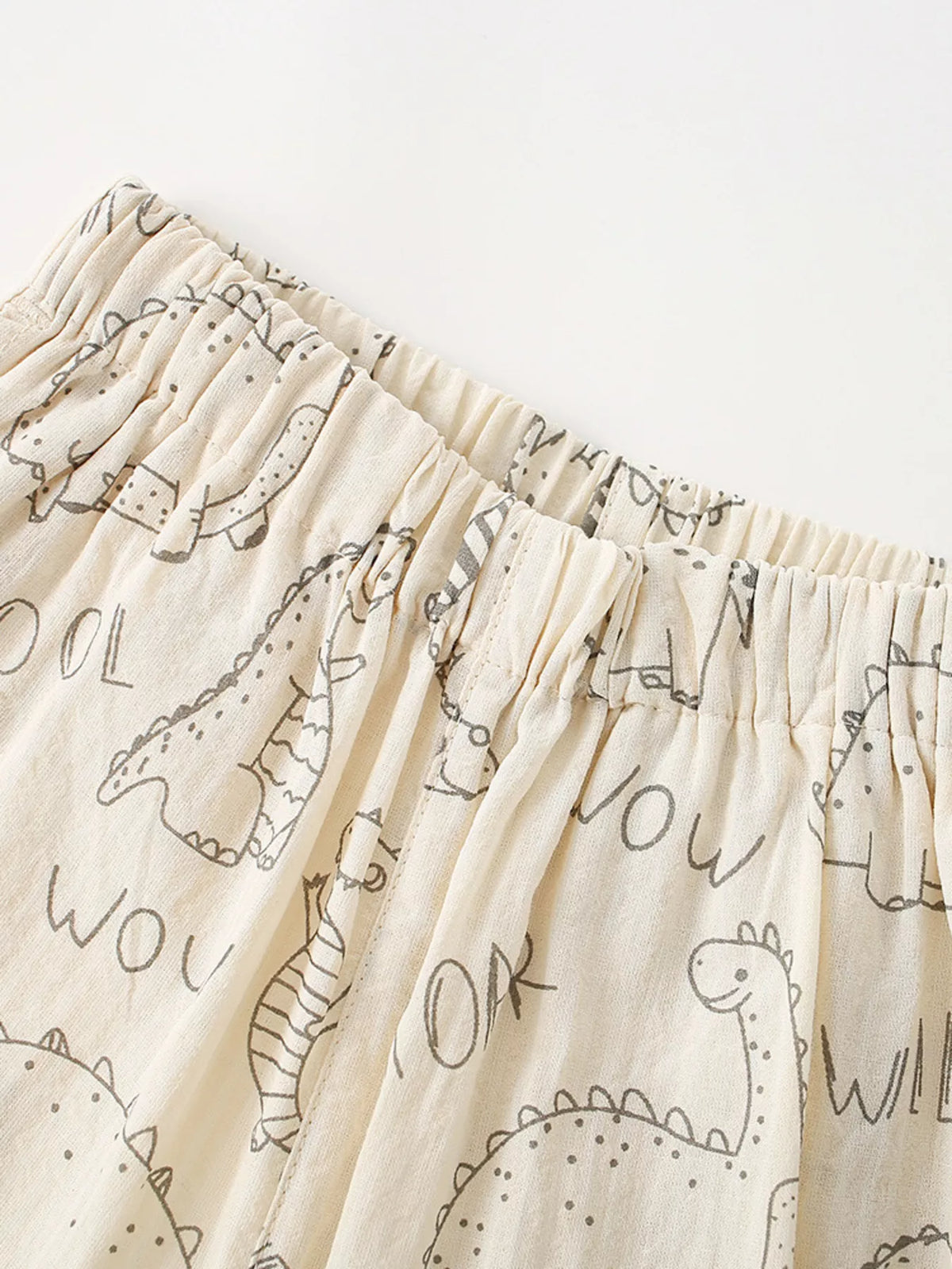 Gathered elastic waistband and dinosaur outlines