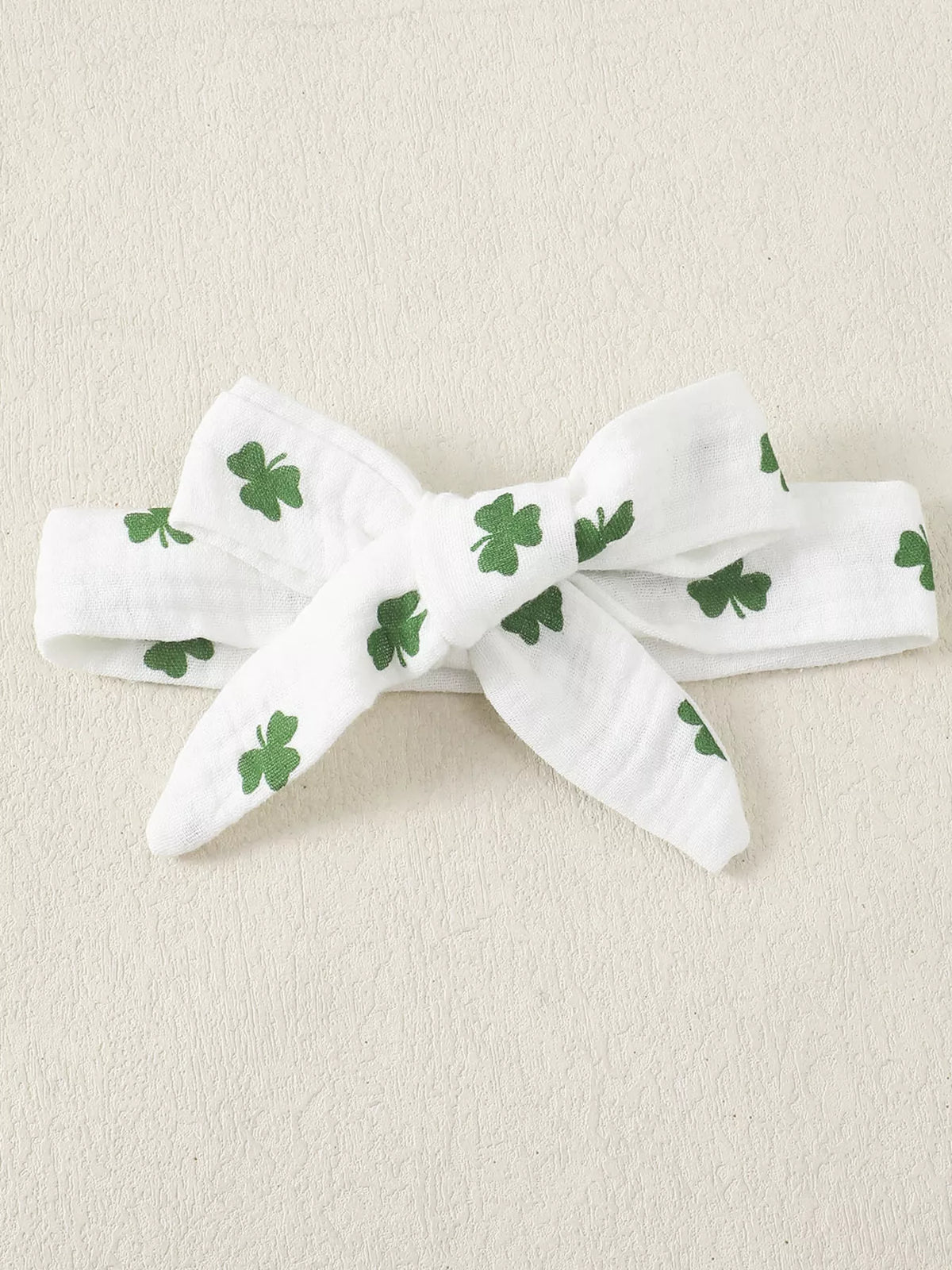 White shamrock ruffle top and flared pants with headband — matching bow headband