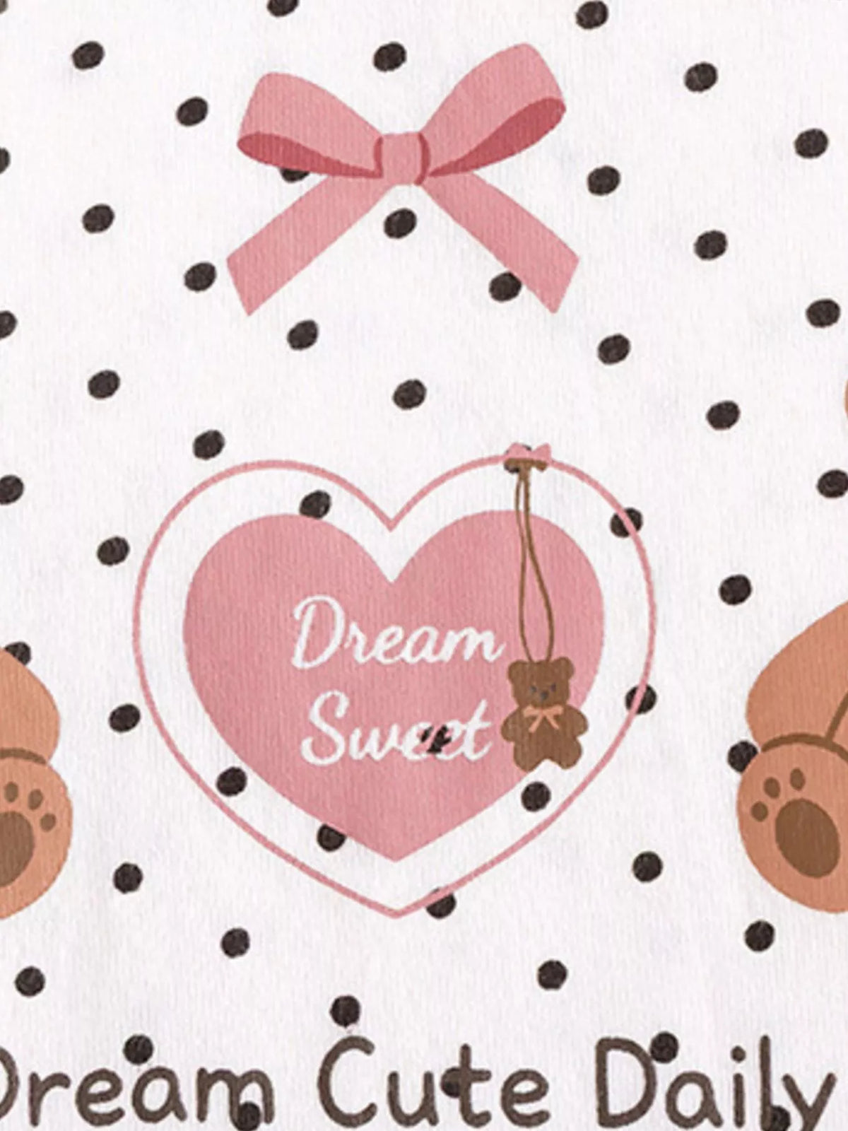 Pink bow, heart and lettering on dotted white fabric