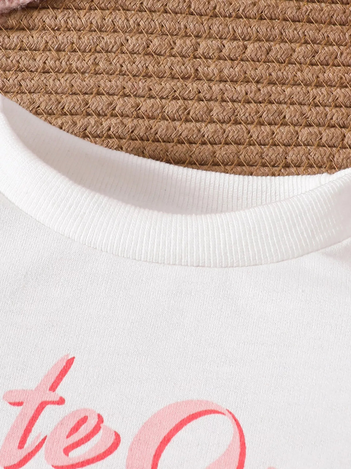 White round neckline and pink lettering