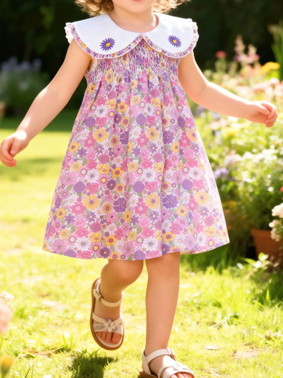Floral smocked dress with a white daisy collar on a child