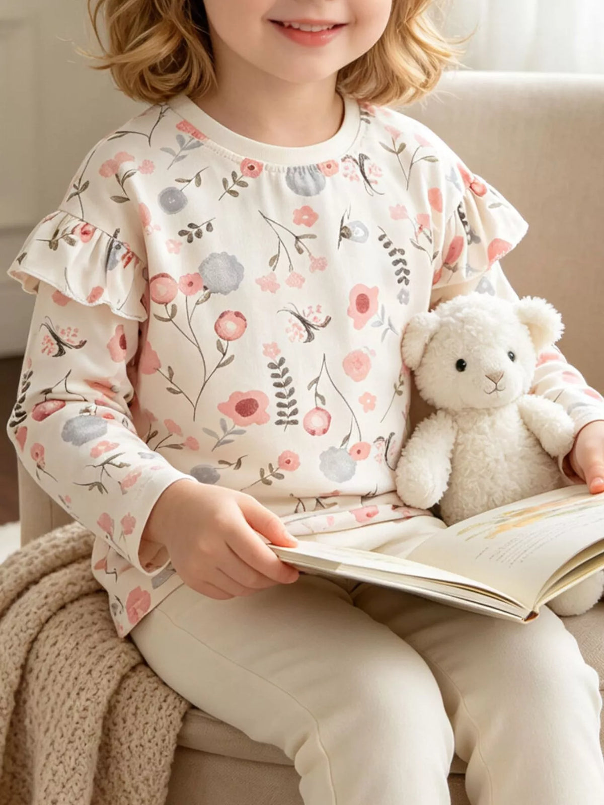 Sweatshirt on a seated child holding a book