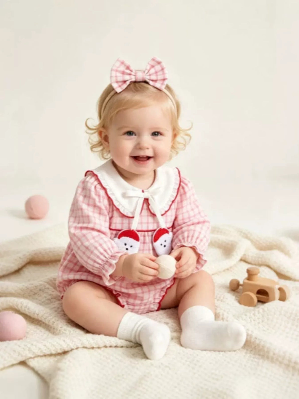 Bodysuit and headband on a seated baby