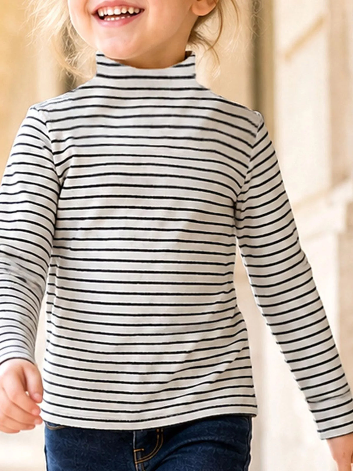 Black-and-white striped long-sleeve turtleneck top on a child