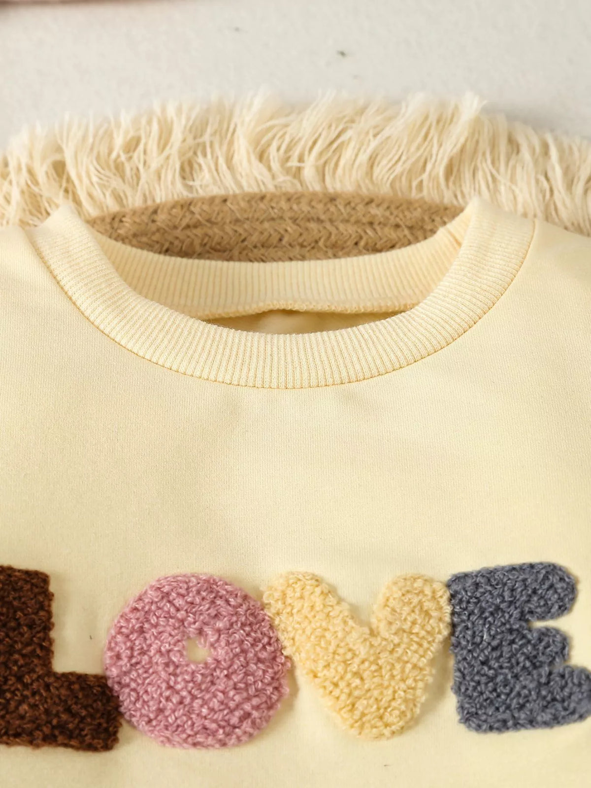 Pale yellow neckline and Love lettering