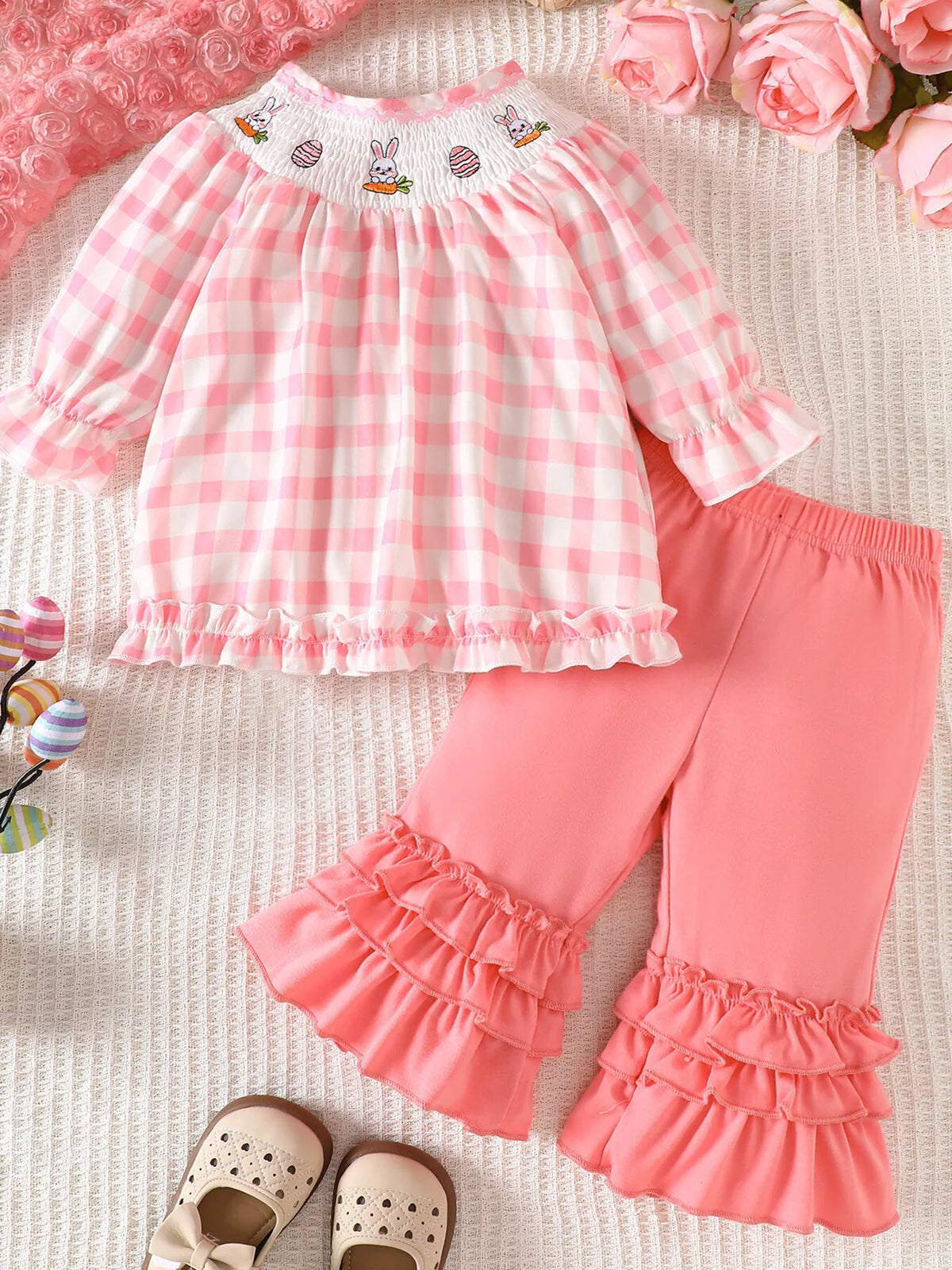 Pink gingham smocked top with ruffle-hem pants laid flat