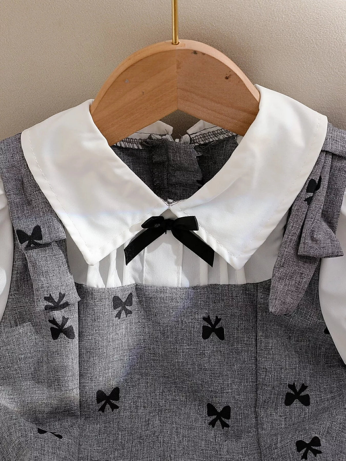 White collar and small black neck bow