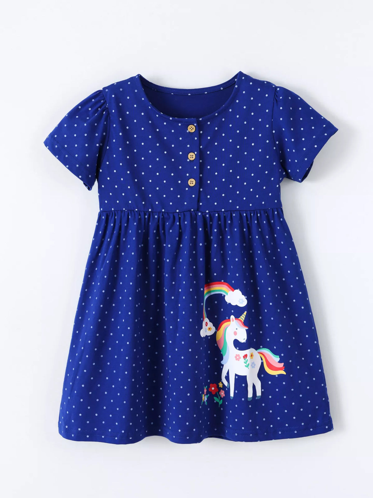Blue polka-dot dress with unicorn and rainbow motifs laid flat