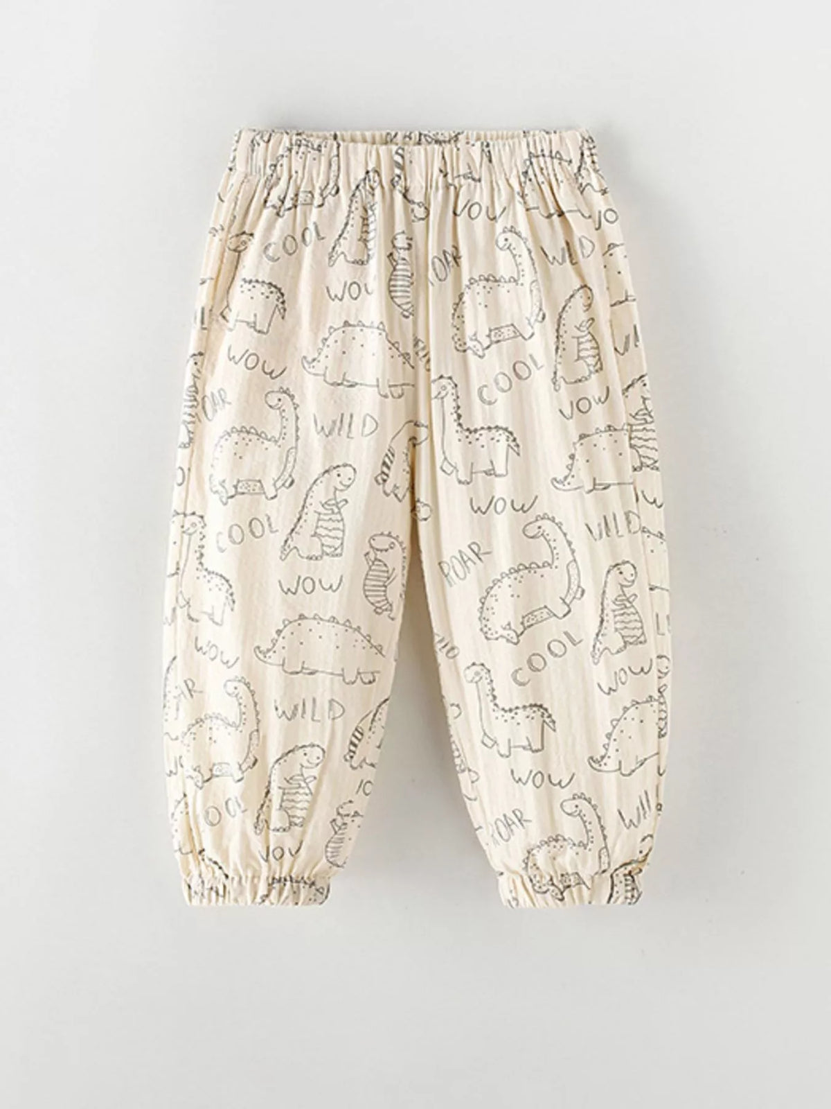 Cream dinosaur-print cuffed pants laid flat