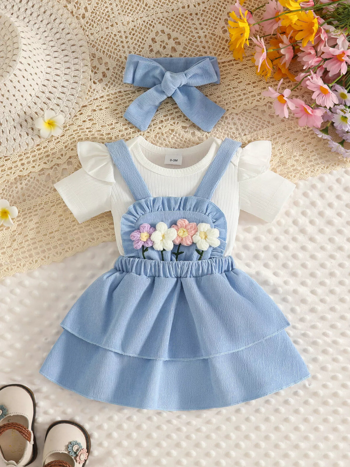 Ribbed floral overall dress and white top set with bow headband — blue outfit front