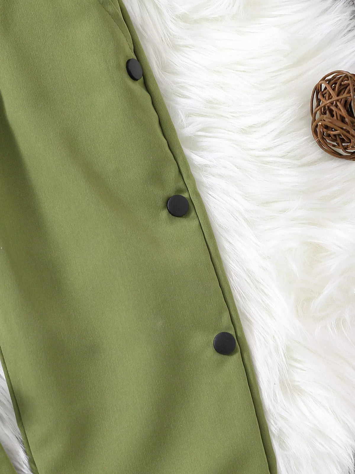 Black buttons along the green pant side