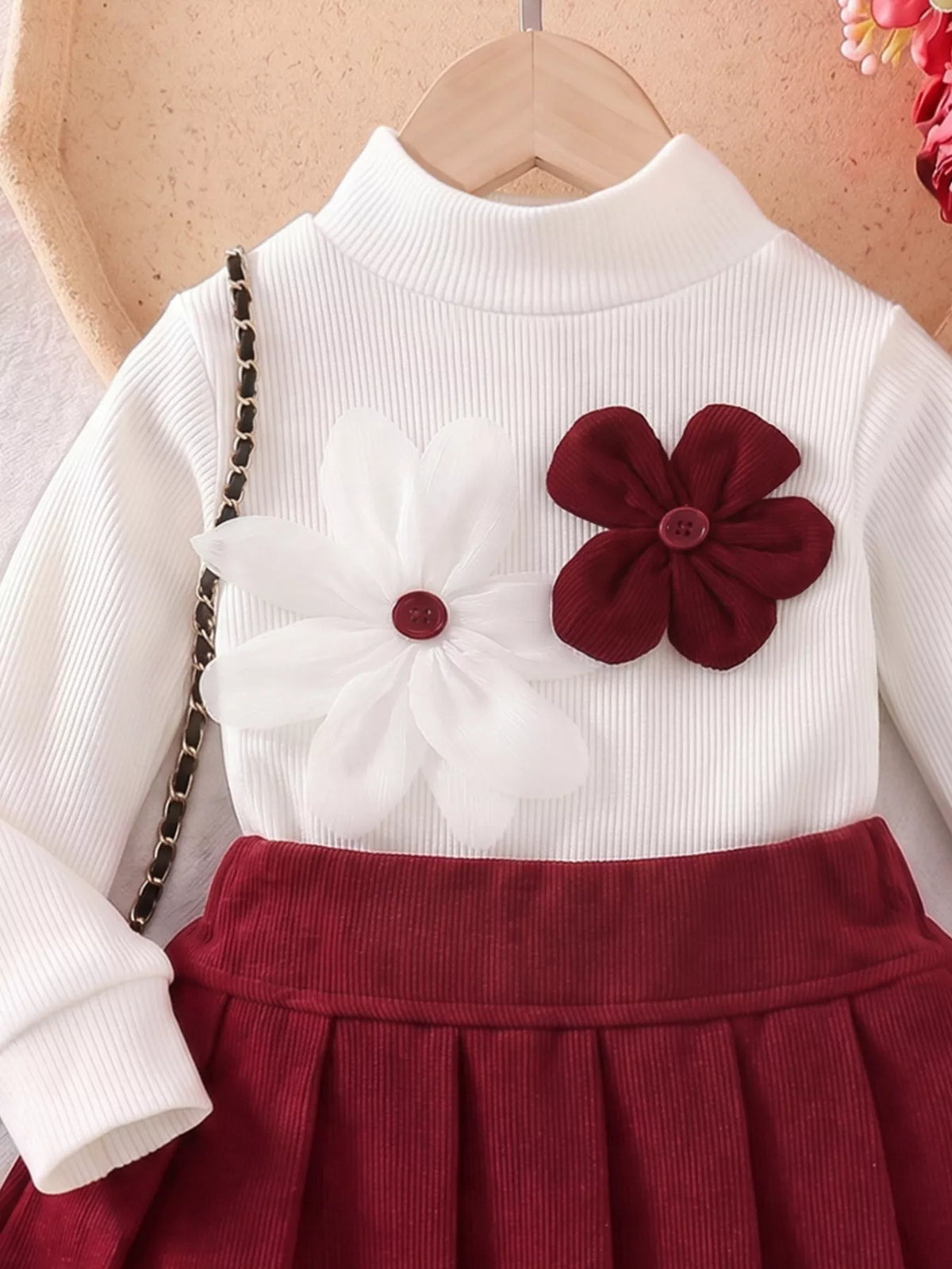 White mock neck and burgundy flower appliques