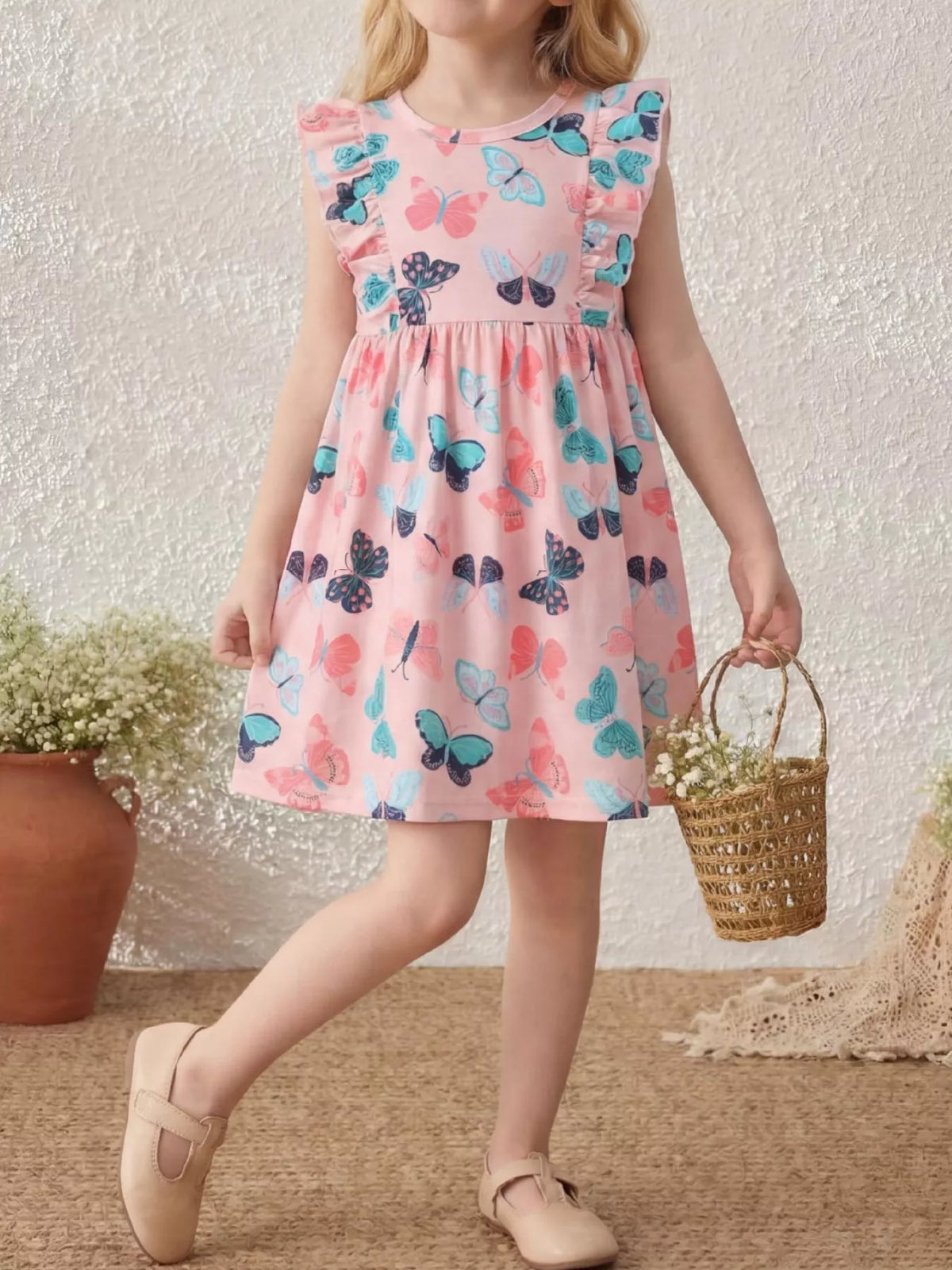 Pink butterfly-print dress with ruffled sleeves on a child