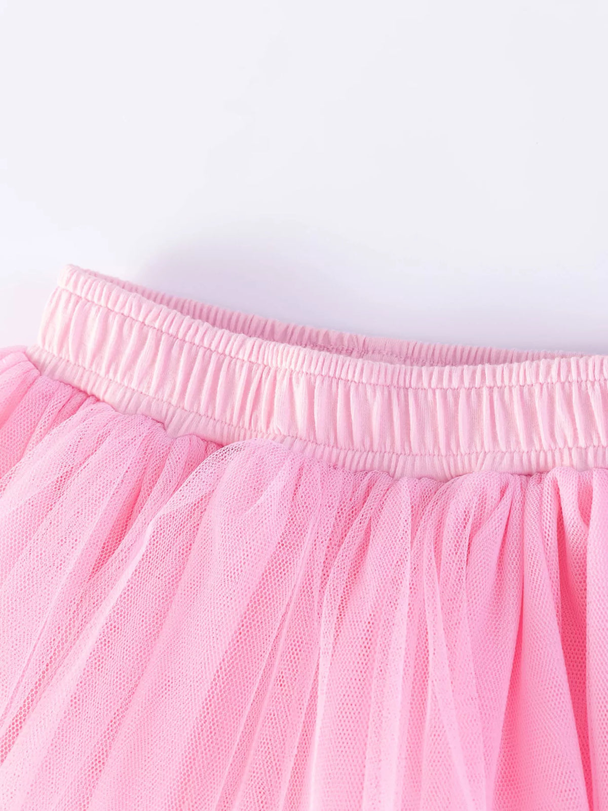 Pink elastic waistband above tulle skirt layers