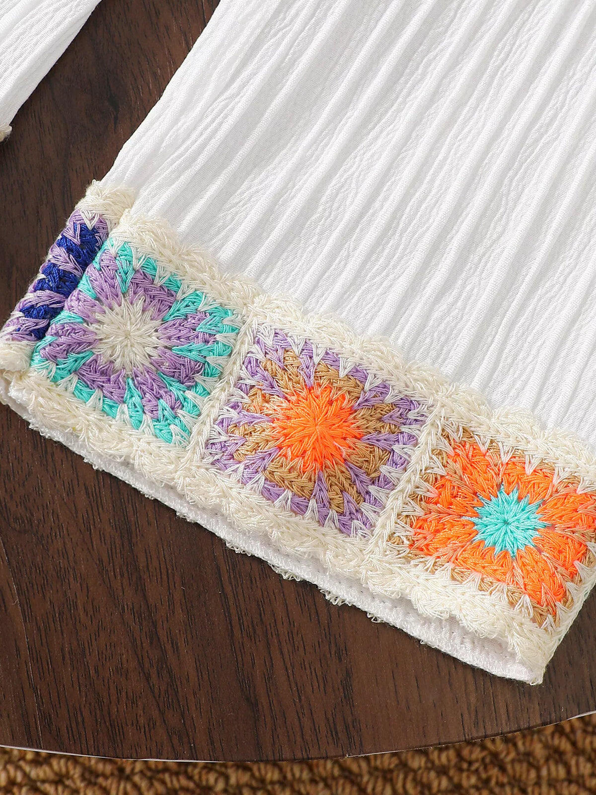 Multicolored crochet flower trim at the pant hem