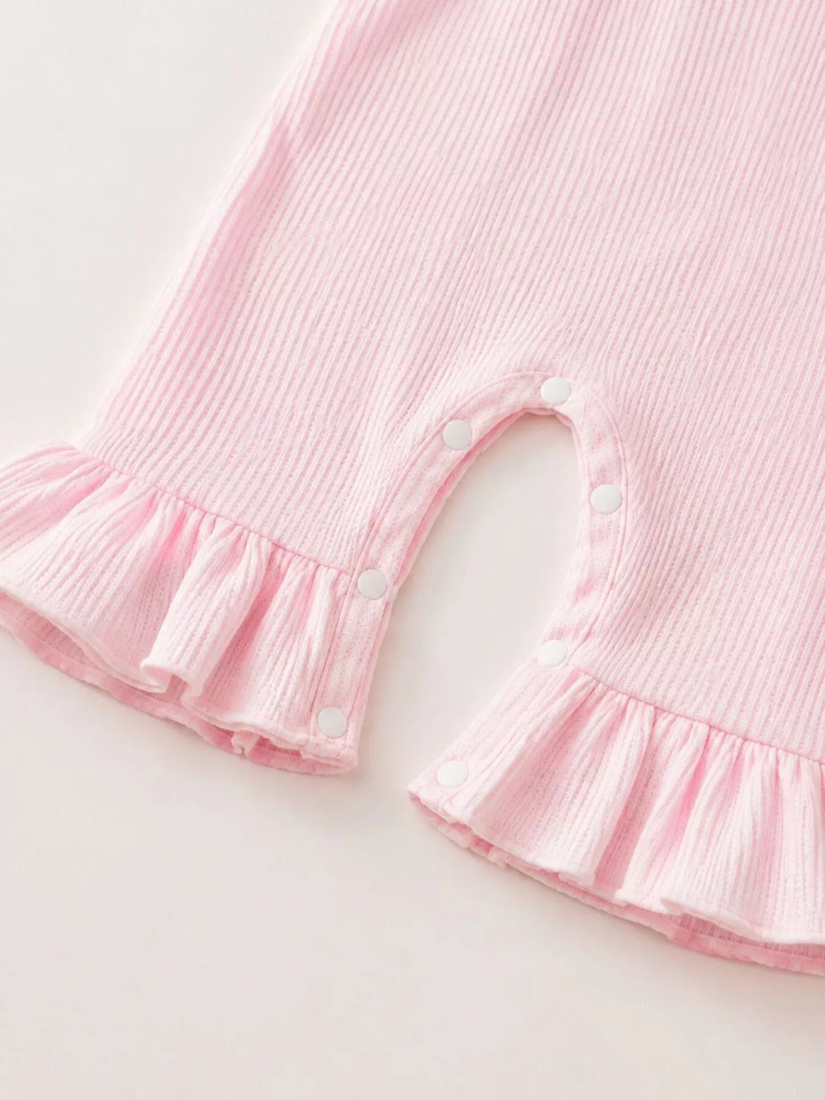 Ruffled cuffs on the pink ribbed pant legs