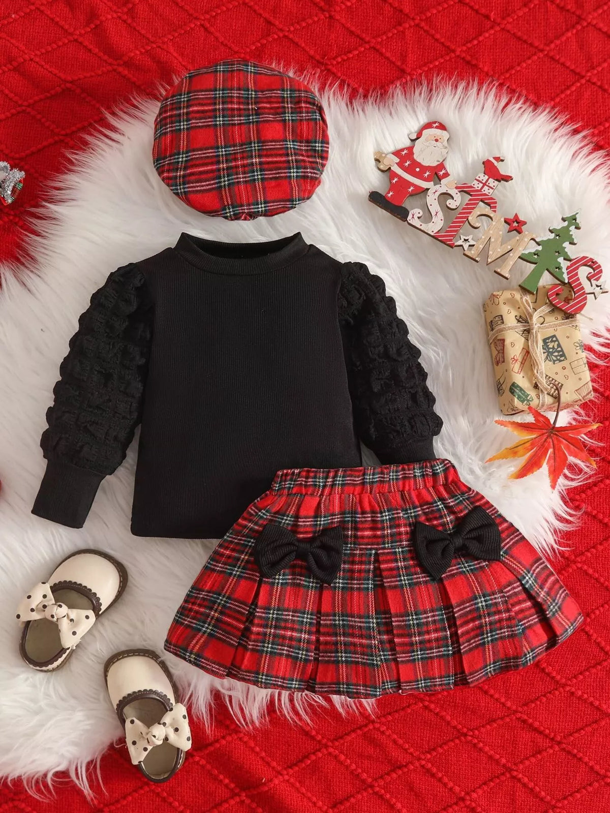Black top with red plaid skirt and hat laid flat