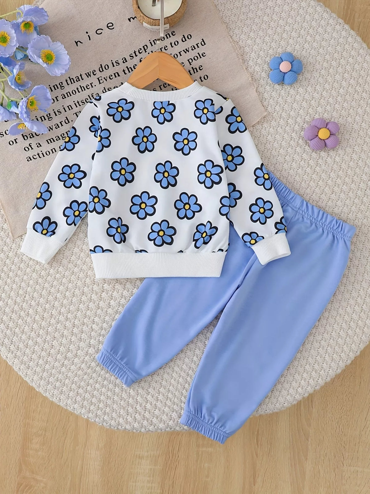 Floral sweatshirt and joggers set — blue outfit laid flat