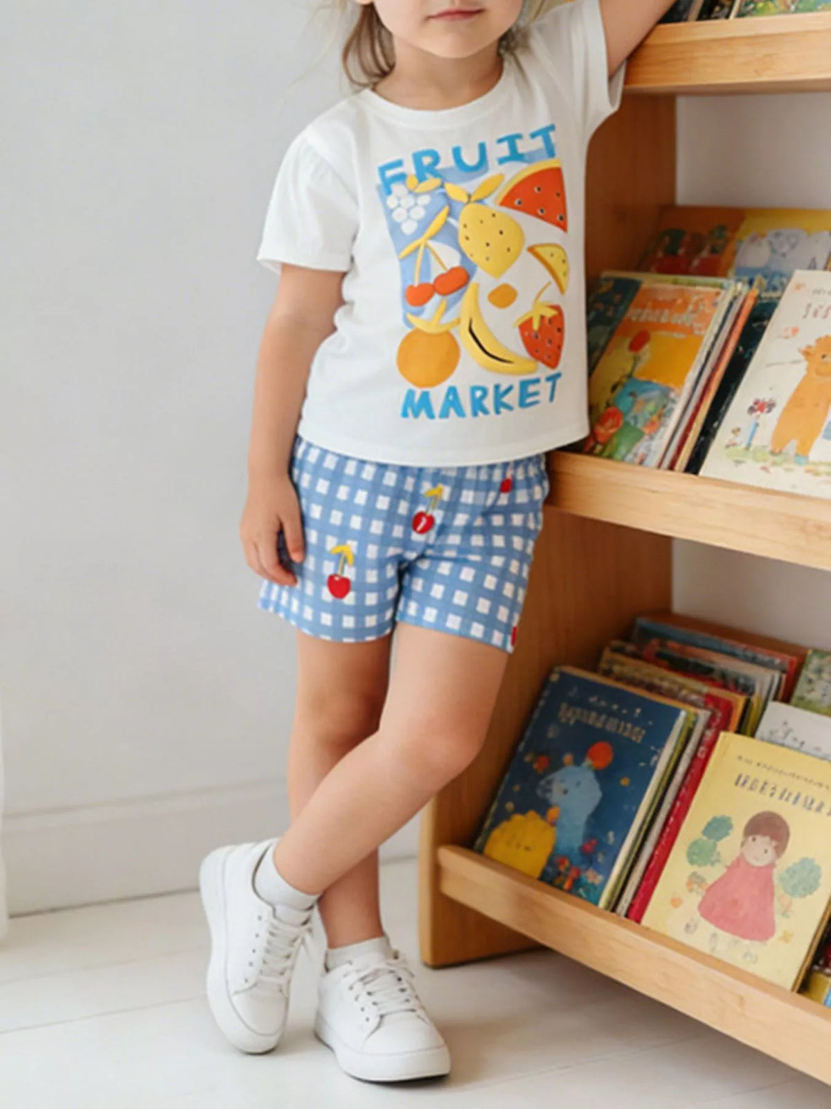 White Fruit Market tee and blue gingham shorts — outfit shown on child
