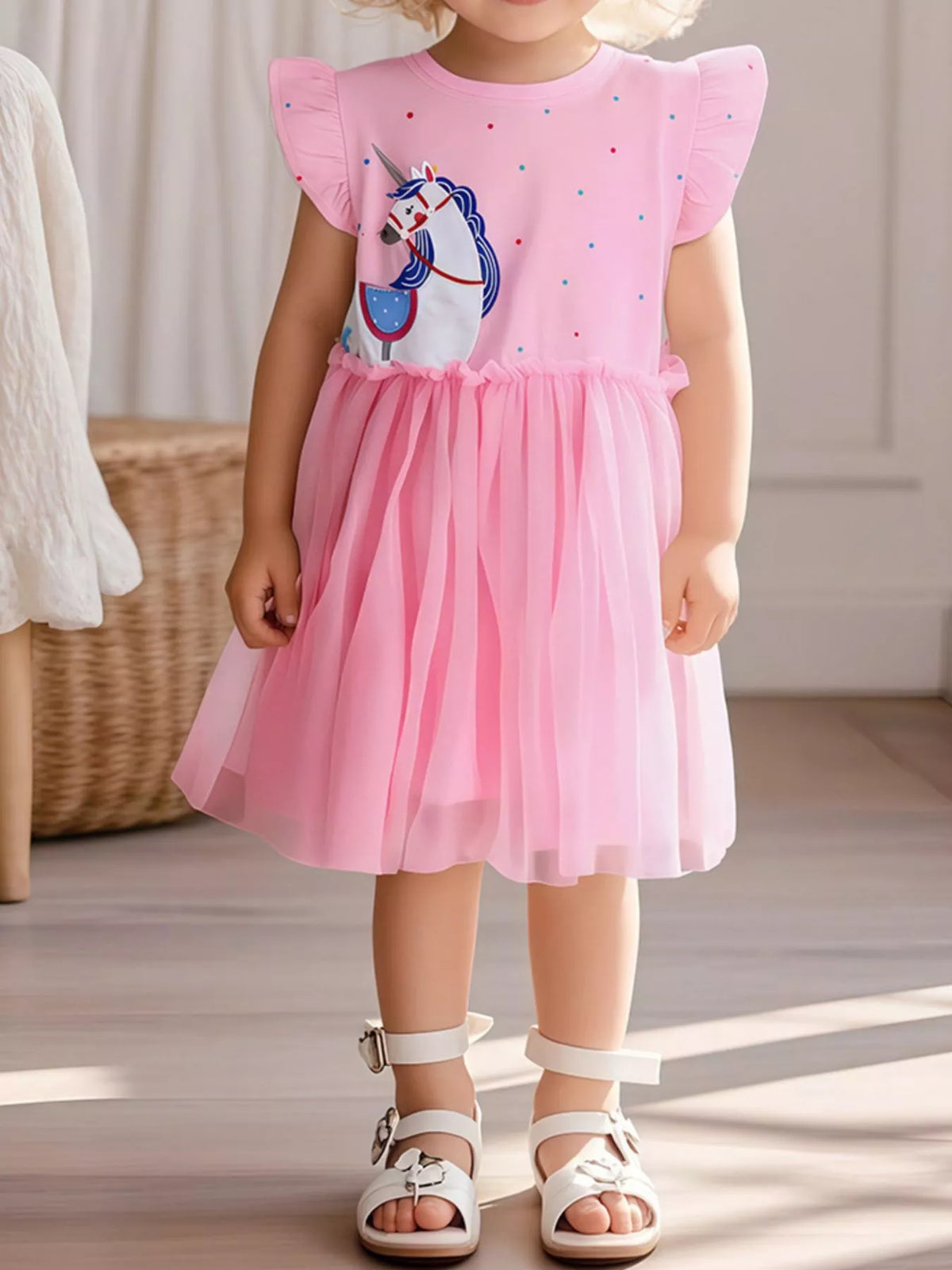 Pink polka-dot unicorn ruffle-sleeve dress with a tulle skirt on a child