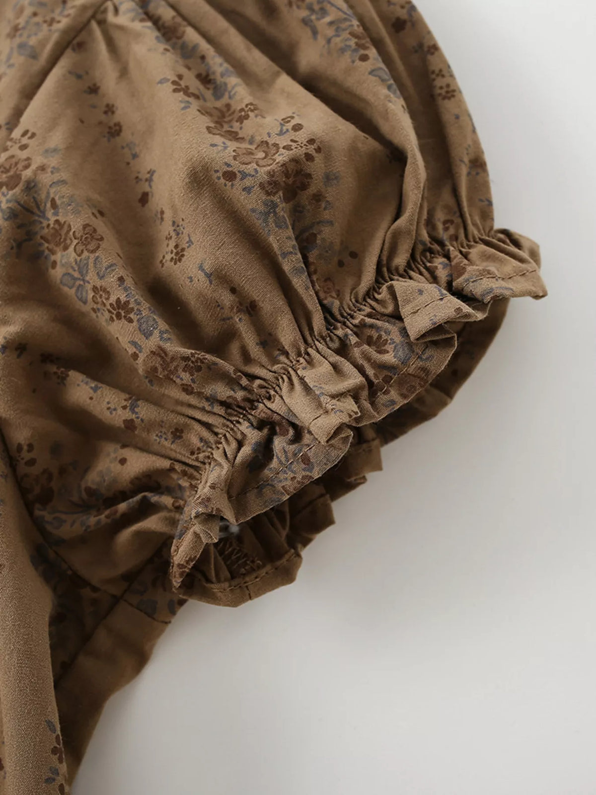 Gathered ruffle cuff on the brown floral sleeve