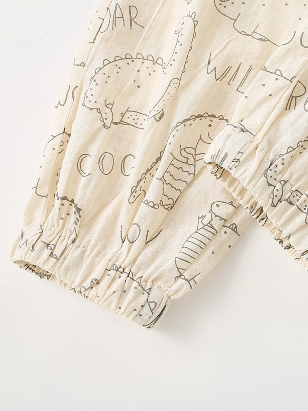 Gathered pant cuffs with dinosaur motifs
