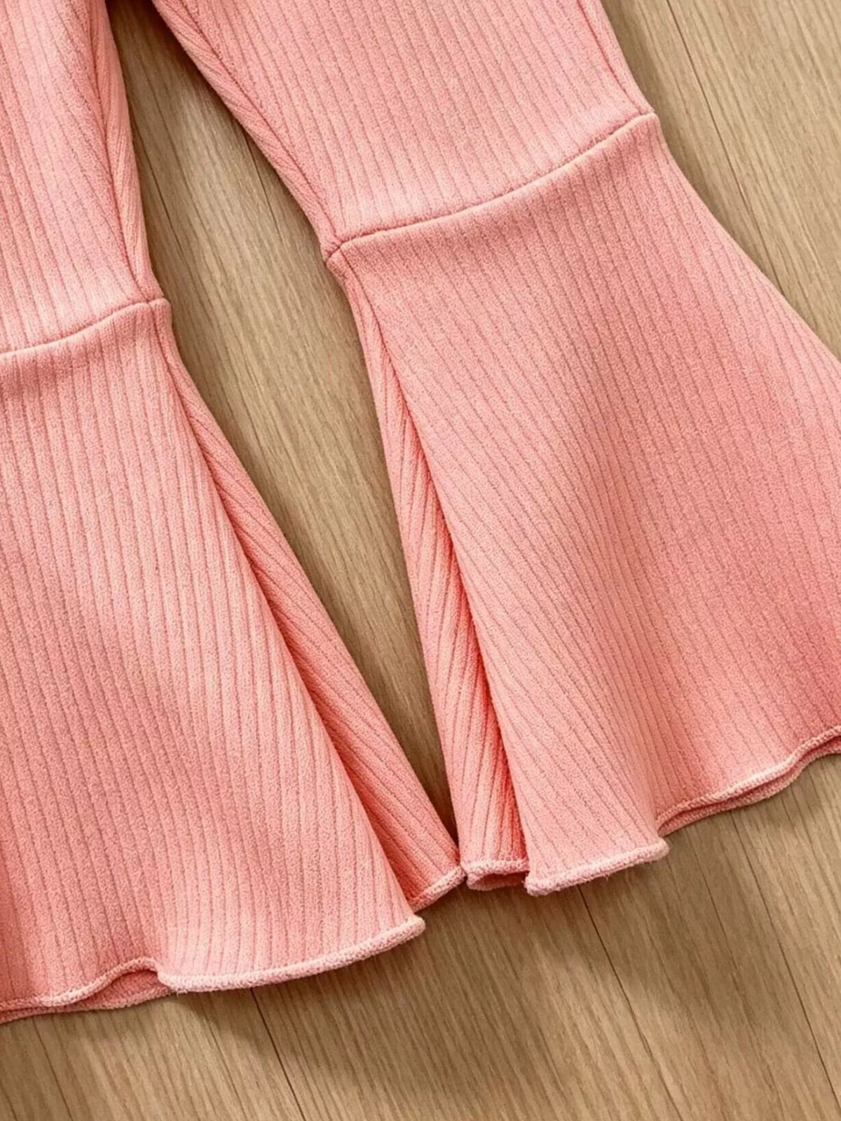 Flared pink ribbed pant hems