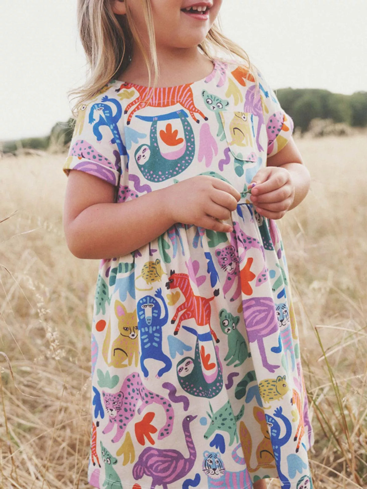White short-sleeve dress with colorful animal motifs on a child