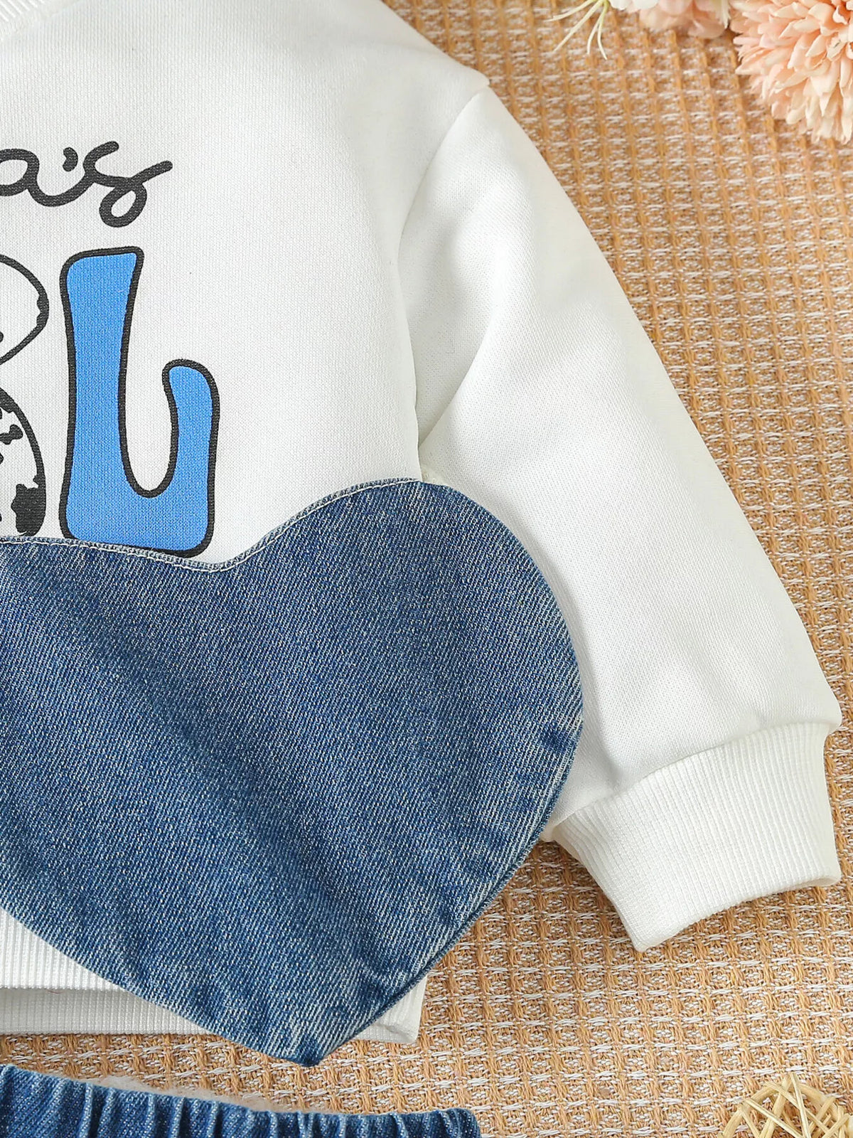 Denim heart bag in front of the sweatshirt