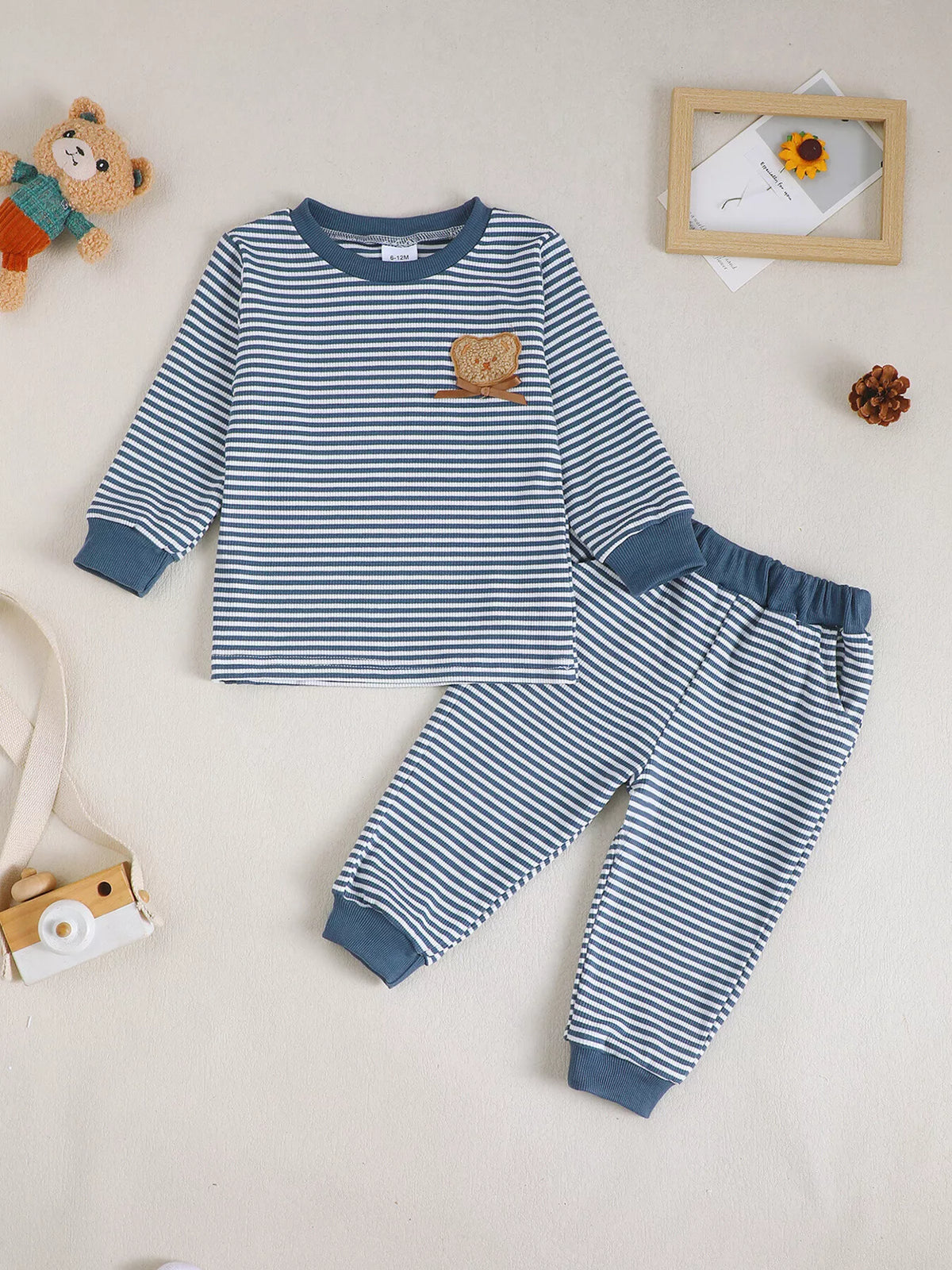 Navy striped top and pants laid flat