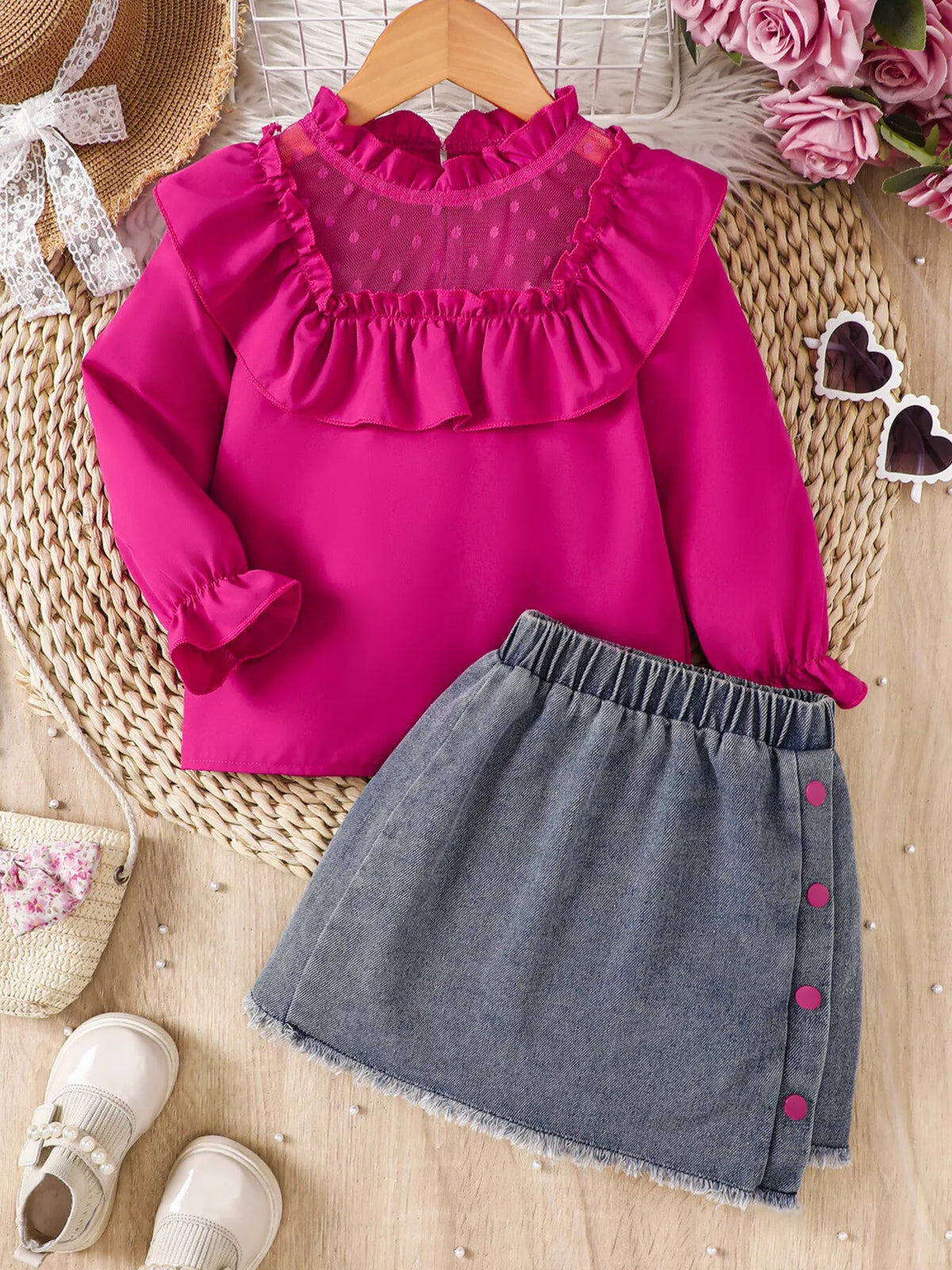 Fuchsia mesh-yoke ruffle top with a gray denim skirt laid flat