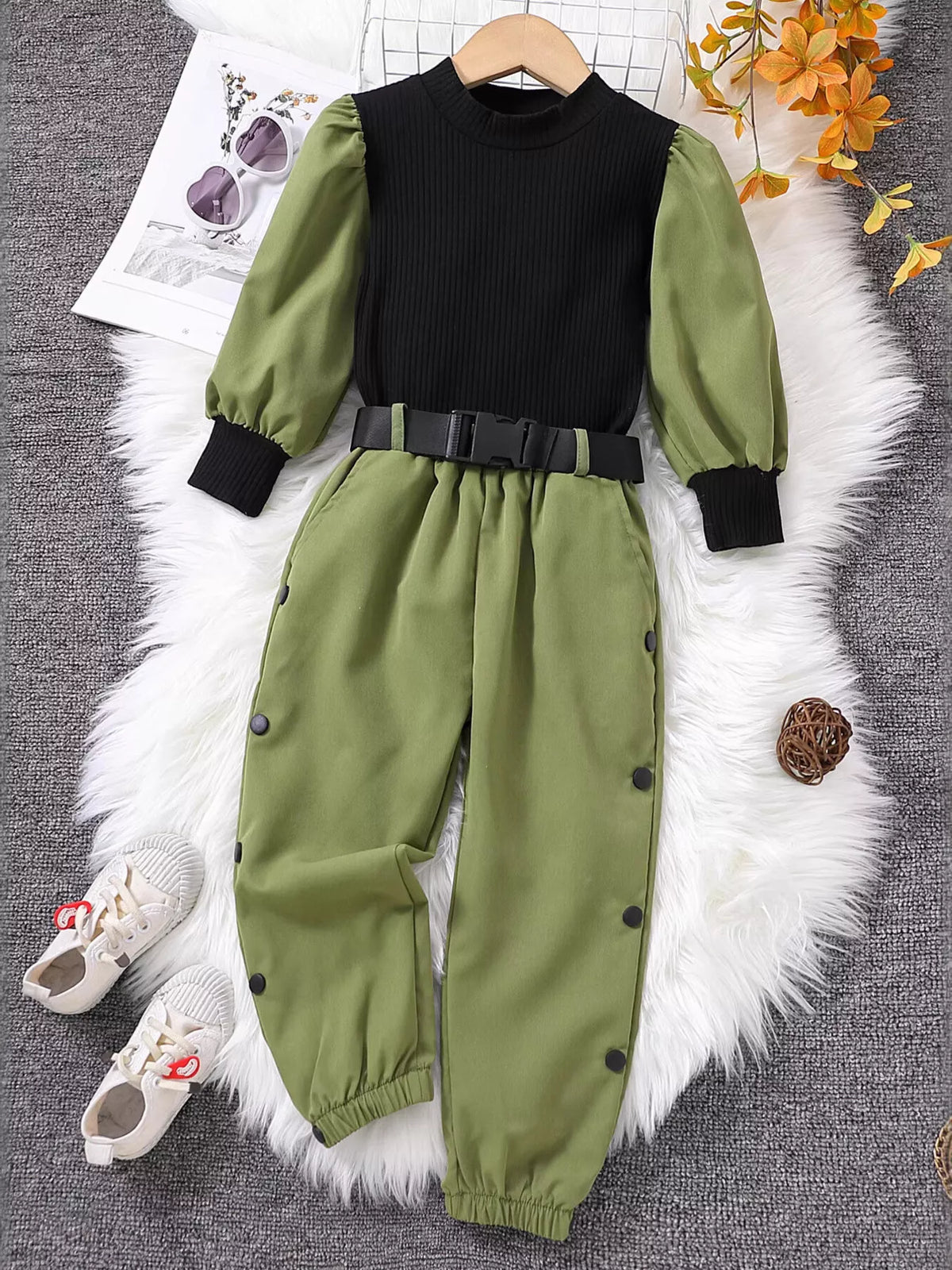Outfit displayed on a hanger with a black belt